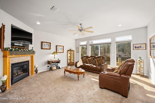 carpeted living room with a tiled fireplace, visible vents, recessed lighting, and ceiling fan