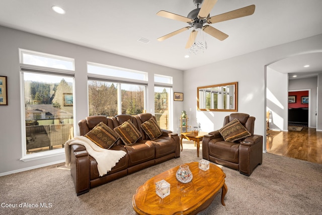 carpeted living area featuring recessed lighting, arched walkways, and ceiling fan