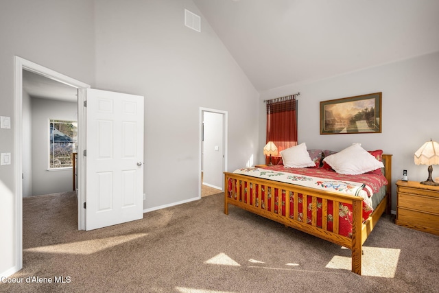 carpeted bedroom with baseboards, visible vents, and high vaulted ceiling