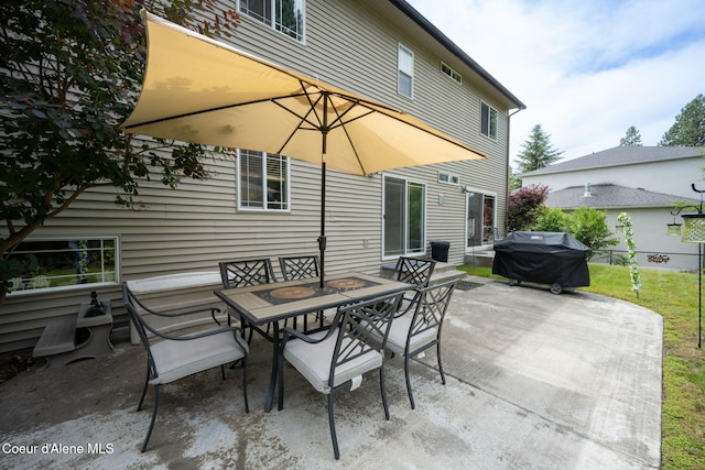 view of patio featuring outdoor dining area, grilling area, and fence