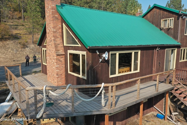 rear view of house featuring a wooden deck