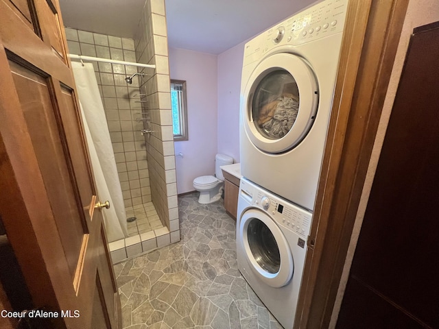 laundry area with stacked washing maching and dryer