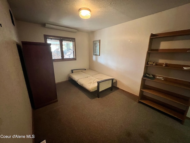 carpeted bedroom with a textured ceiling