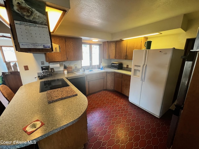 kitchen featuring dishwashing machine, white fridge with ice dispenser, a textured ceiling, black electric stovetop, and sink