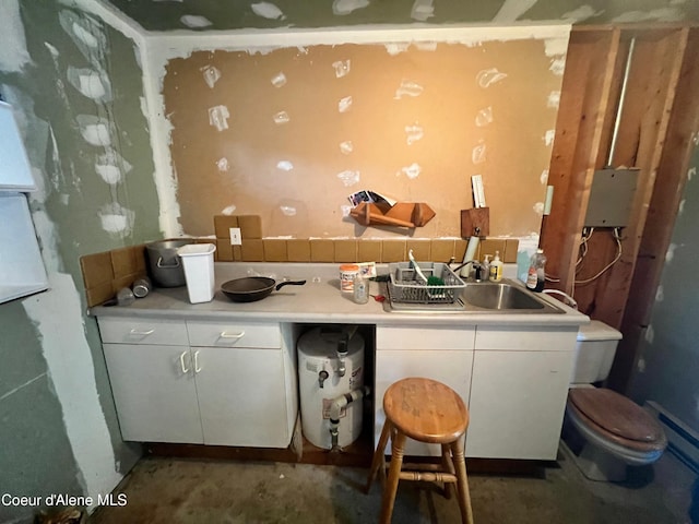 kitchen featuring sink, white cabinetry, and a breakfast bar