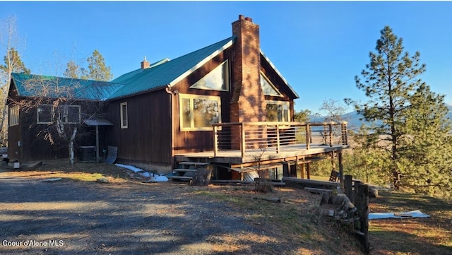 view of side of property with a wooden deck