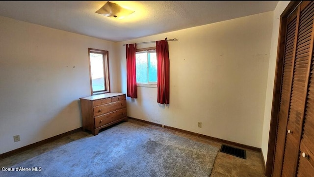 unfurnished bedroom with carpet floors and a closet