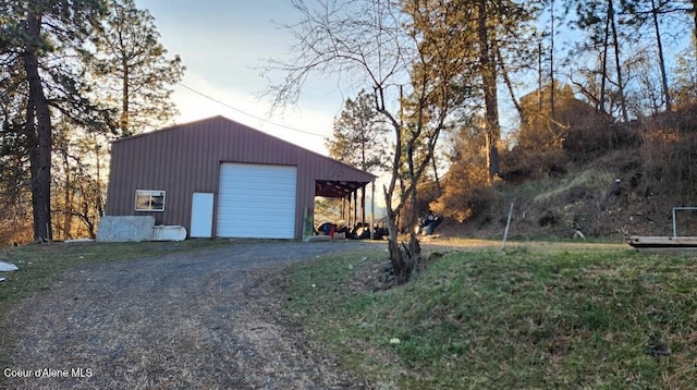 view of garage at dusk