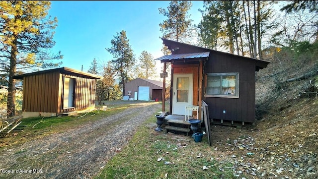 exterior space with a garage and an outdoor structure