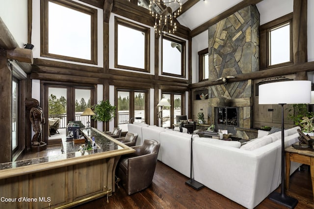 16692 S Lazurite Dr, Coeur Dalene, ID 83814 - living room featuring an inviting chandelier, french doors, a towering ceiling, log walls, and dark hardwood / wood-style flooring