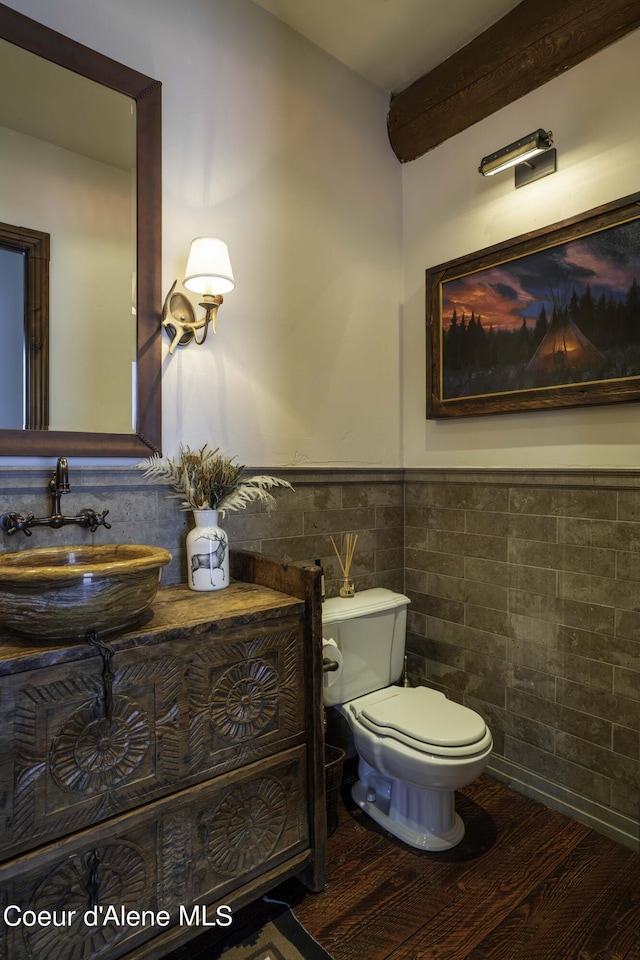 16692 S Lazurite Dr, Coeur Dalene, ID 83814 - bathroom with sink, beamed ceiling, toilet, tile walls, and hardwood / wood-style flooring