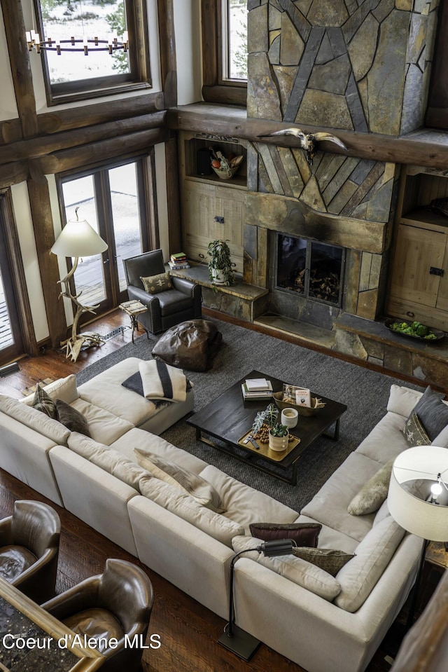 16692 S Lazurite Dr, Coeur Dalene, ID 83814 - living room featuring a fireplace, a high ceiling, and dark wood-type flooring