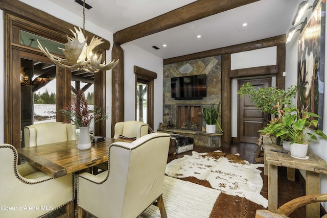 16692 S Lazurite Dr, Coeur Dalene, ID 83814 - dining space featuring hardwood / wood-style floors, an inviting chandelier, and a stone fireplace