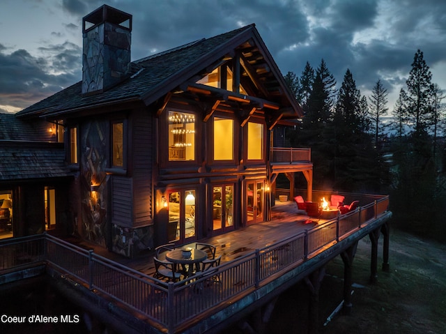 16692 S Lazurite Dr, Coeur Dalene, ID 83814 - back house at dusk featuring a wooden deck and french doors
