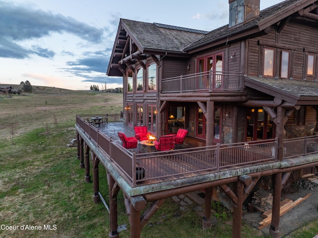 16692 S Lazurite Dr, Coeur Dalene, ID 83814 - deck at dusk with french doors, a rural view, and a fire pit