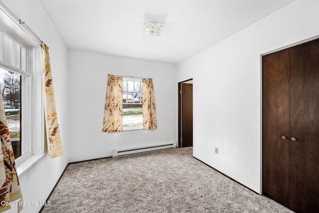 unfurnished bedroom with carpet, a closet, and a baseboard radiator