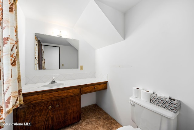 bathroom with decorative backsplash, vanity, and toilet