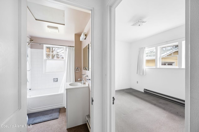 bathroom featuring vanity, plenty of natural light, shower / bathtub combination with curtain, and a baseboard heating unit