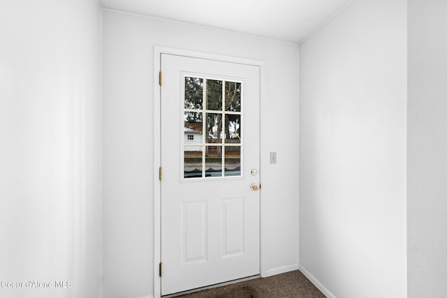 entryway featuring dark carpet