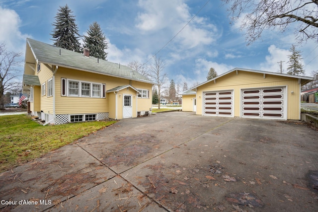 view of property exterior featuring a garage and a yard