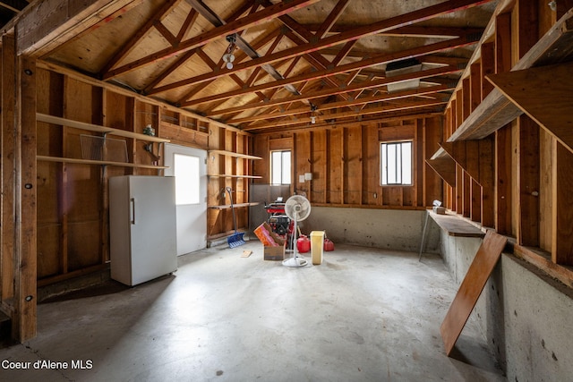 misc room featuring lofted ceiling and concrete flooring