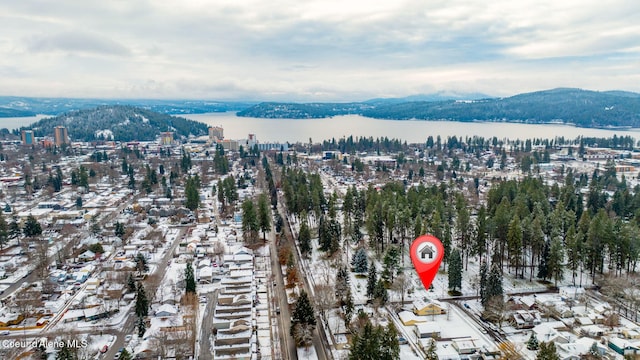 birds eye view of property with a water and mountain view