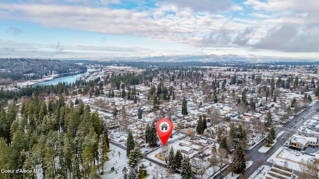 snowy aerial view with a water view