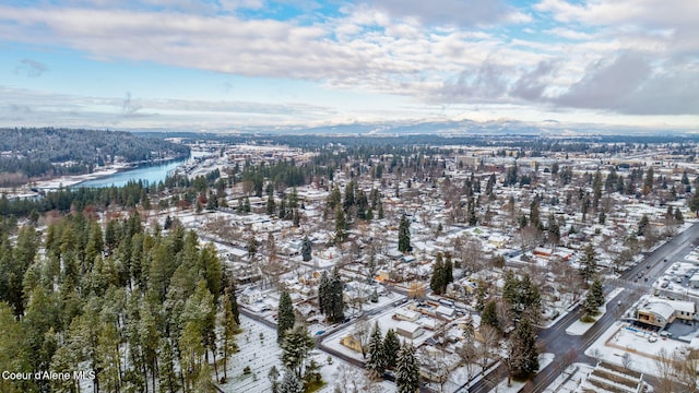 snowy aerial view with a water and mountain view