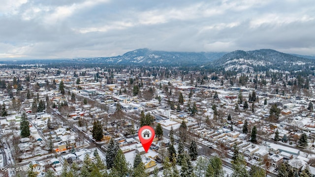 snowy aerial view featuring a mountain view