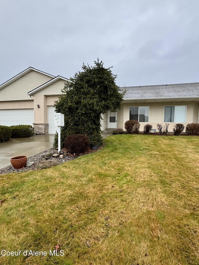 single story home featuring a front yard and a garage