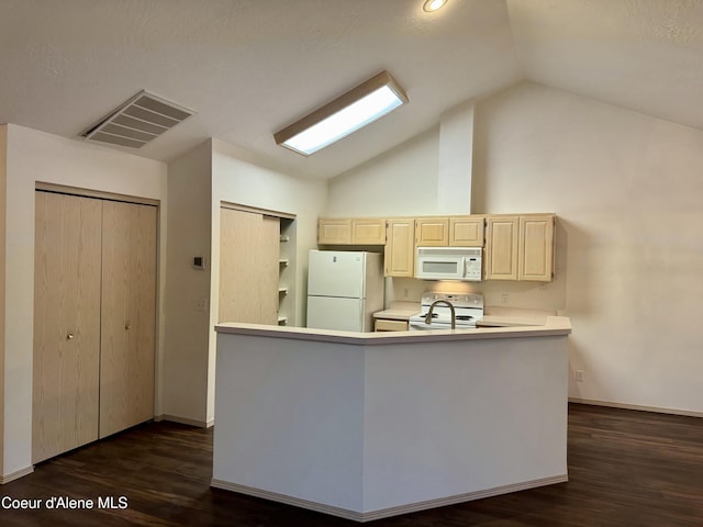 kitchen with lofted ceiling, white appliances, and dark wood-type flooring