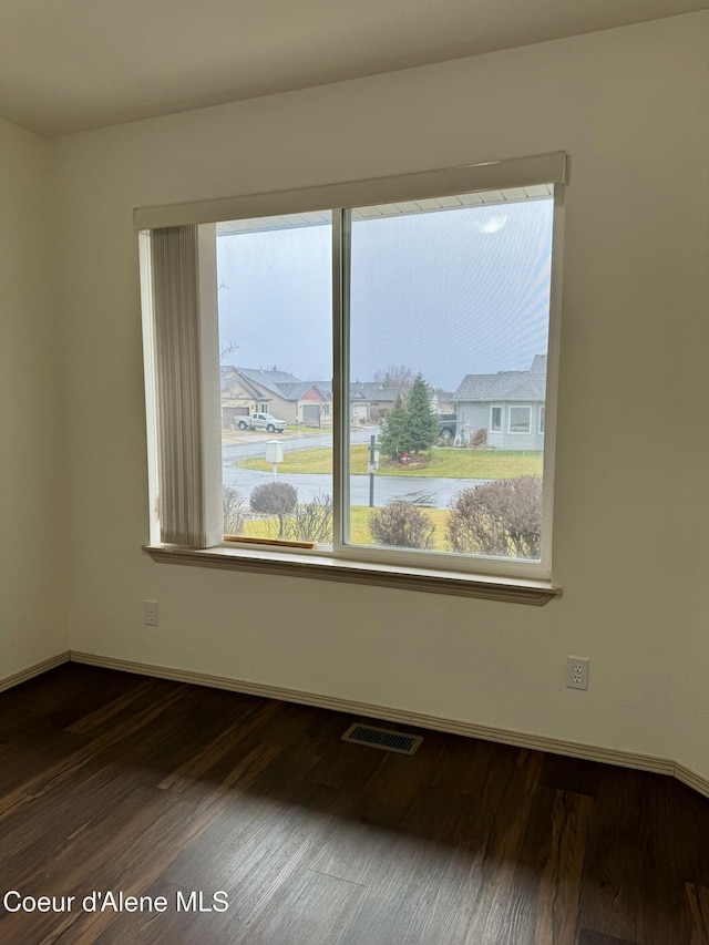 spare room featuring dark hardwood / wood-style floors