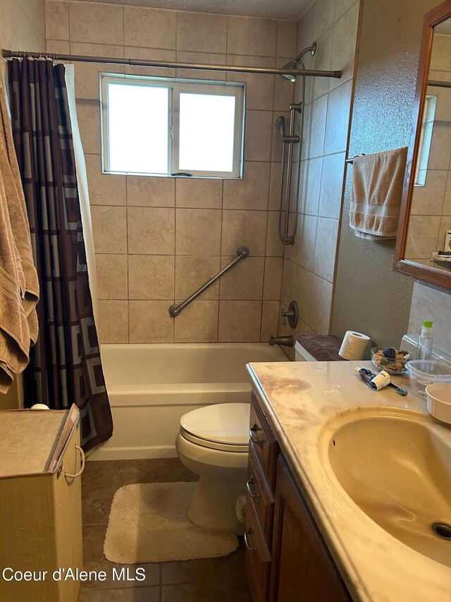 full bathroom with toilet, vanity, tile patterned floors, and shower / bath combo with shower curtain