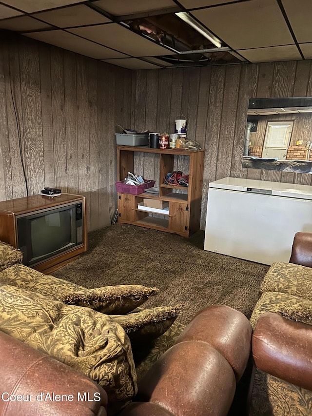 interior space featuring a drop ceiling, dark brown cabinets, and carpet floors