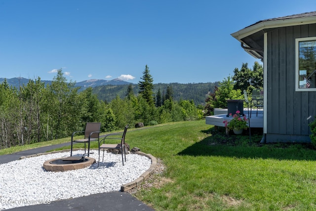 view of yard featuring a mountain view and a fire pit