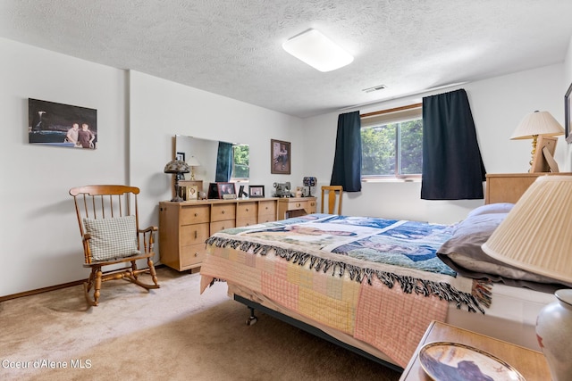 carpeted bedroom featuring a textured ceiling