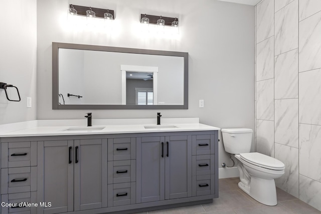 bathroom featuring tile patterned flooring, vanity, and toilet