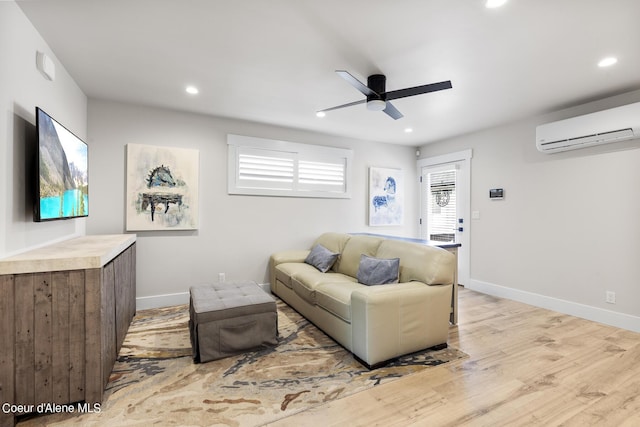 living room featuring ceiling fan, light hardwood / wood-style floors, and a wall unit AC