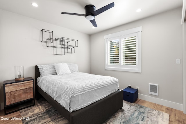 bedroom with ceiling fan and hardwood / wood-style flooring