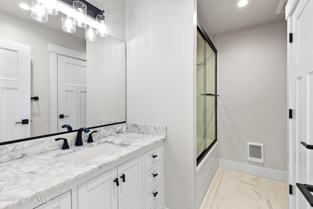 bathroom featuring vanity and enclosed tub / shower combo