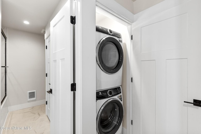 laundry room featuring stacked washer / dryer