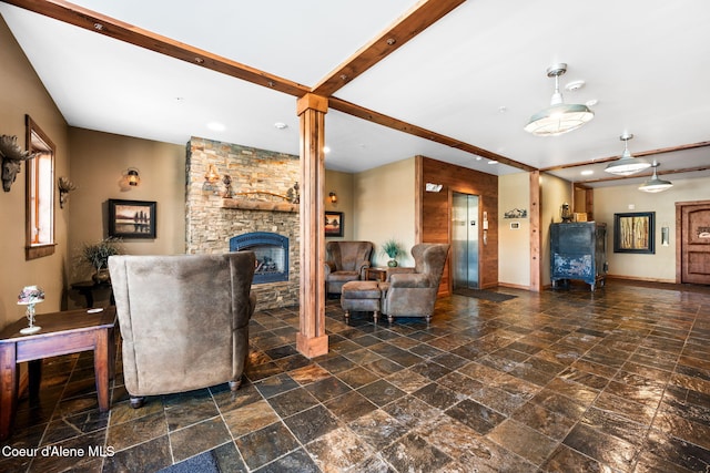 living room with beam ceiling, a fireplace, and elevator