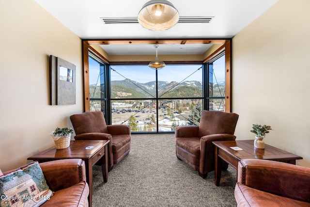 carpeted living room with a mountain view