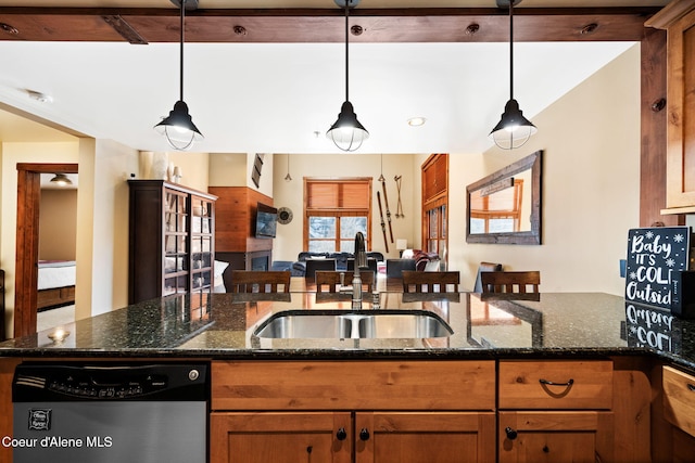 kitchen featuring stainless steel dishwasher, dark stone counters, and hanging light fixtures