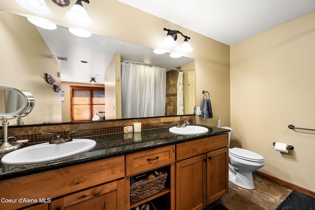 bathroom featuring vanity and toilet