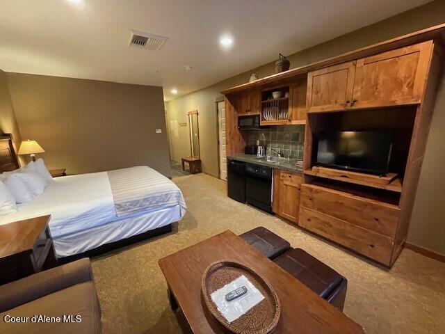 carpeted bedroom with sink