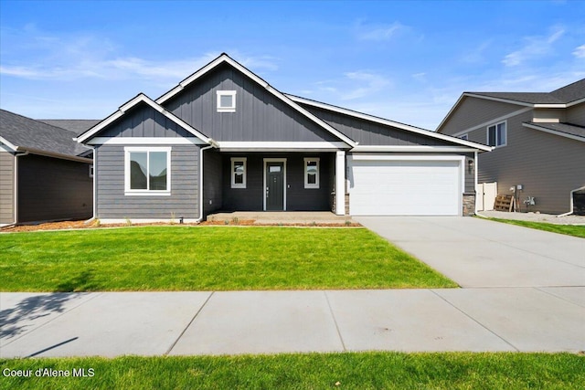 view of front of property with a garage and a front lawn