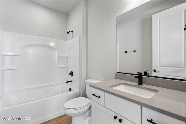 full bathroom featuring toilet, vanity, hardwood / wood-style flooring, and bathing tub / shower combination