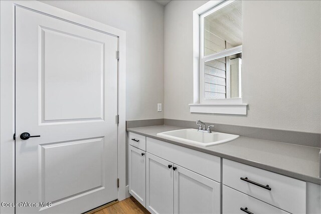 bathroom with hardwood / wood-style floors and vanity