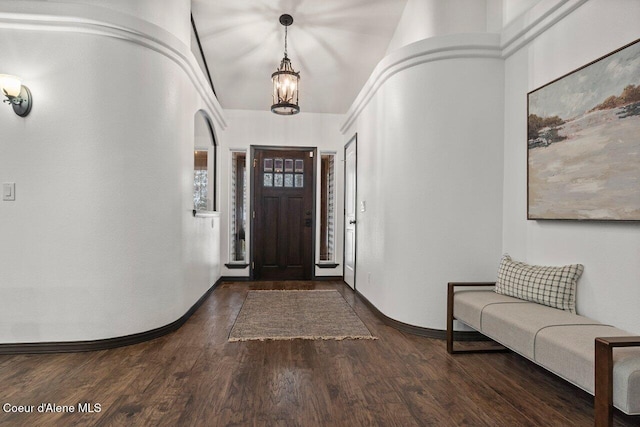 entrance foyer featuring a notable chandelier and dark hardwood / wood-style floors